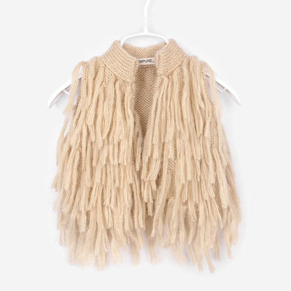 Front view of a baby girl's knitted tassel shrug, versatile sleeveless sweater for cool weather.