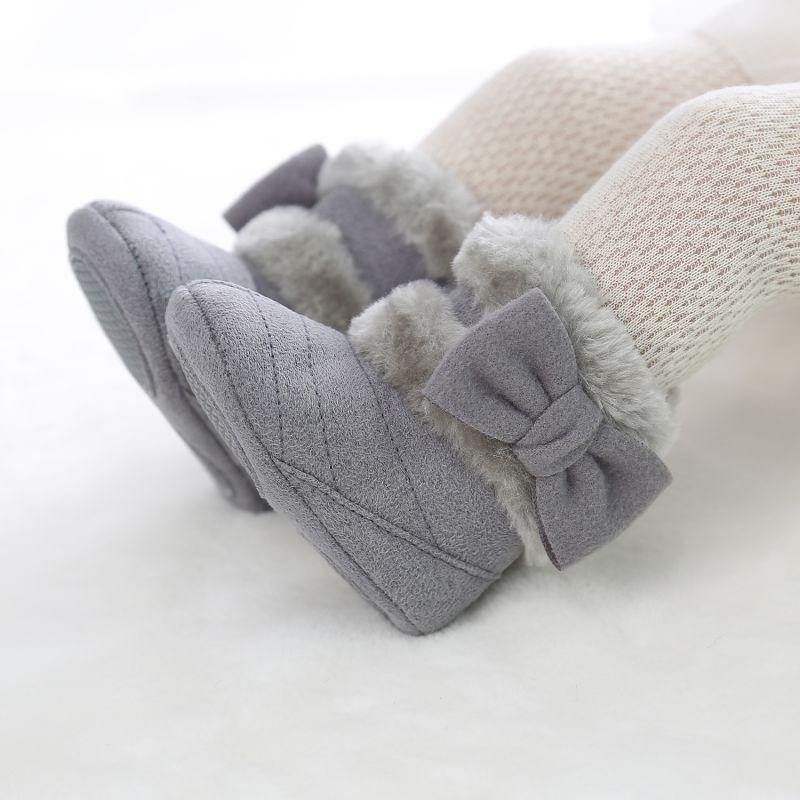 Cozy baby girl's bow winter boots, light pink, with secure velcro closure, perfect for cold weather