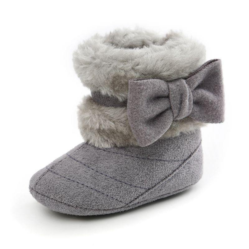 Infant girl's anti-slip suede boots with an adorable bow detail, ideal for first steps in winter