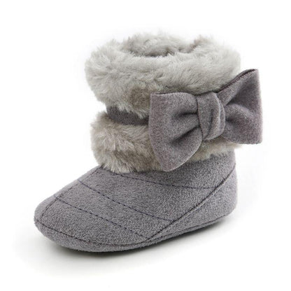 Infant girl's anti-slip suede boots with an adorable bow detail, ideal for first steps in winter