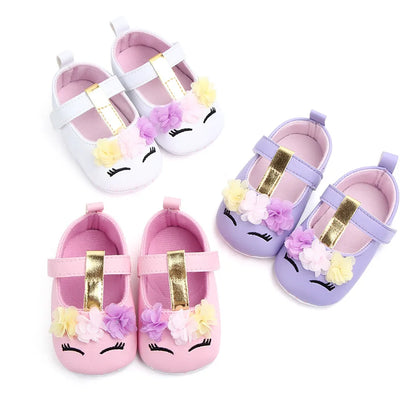 Baby girl's pre-walking soft sole shoes with flower detail, perfect for first steps.