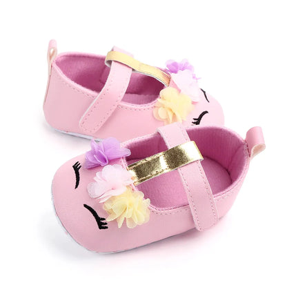Baby girl's pre-walking shoes, soft sole and flower design, perfect for new walkers.