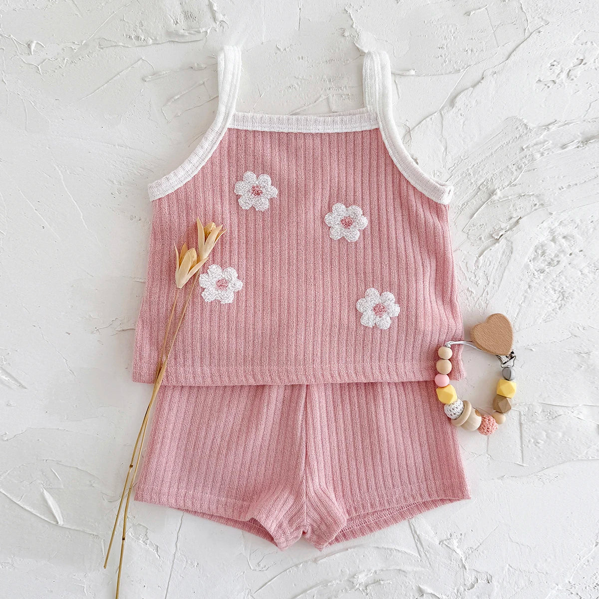 Infant girl's casual summer outfit: ribbed camisole with floral design and matching cotton blend shorts.