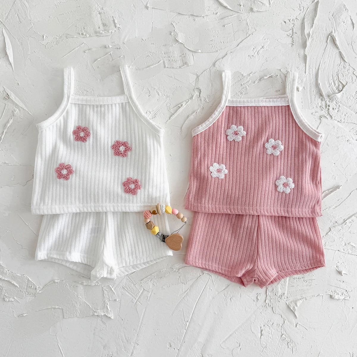 Two-piece baby girl summer outfit featuring a ribbed knit camisole with delicate floral embroidery.