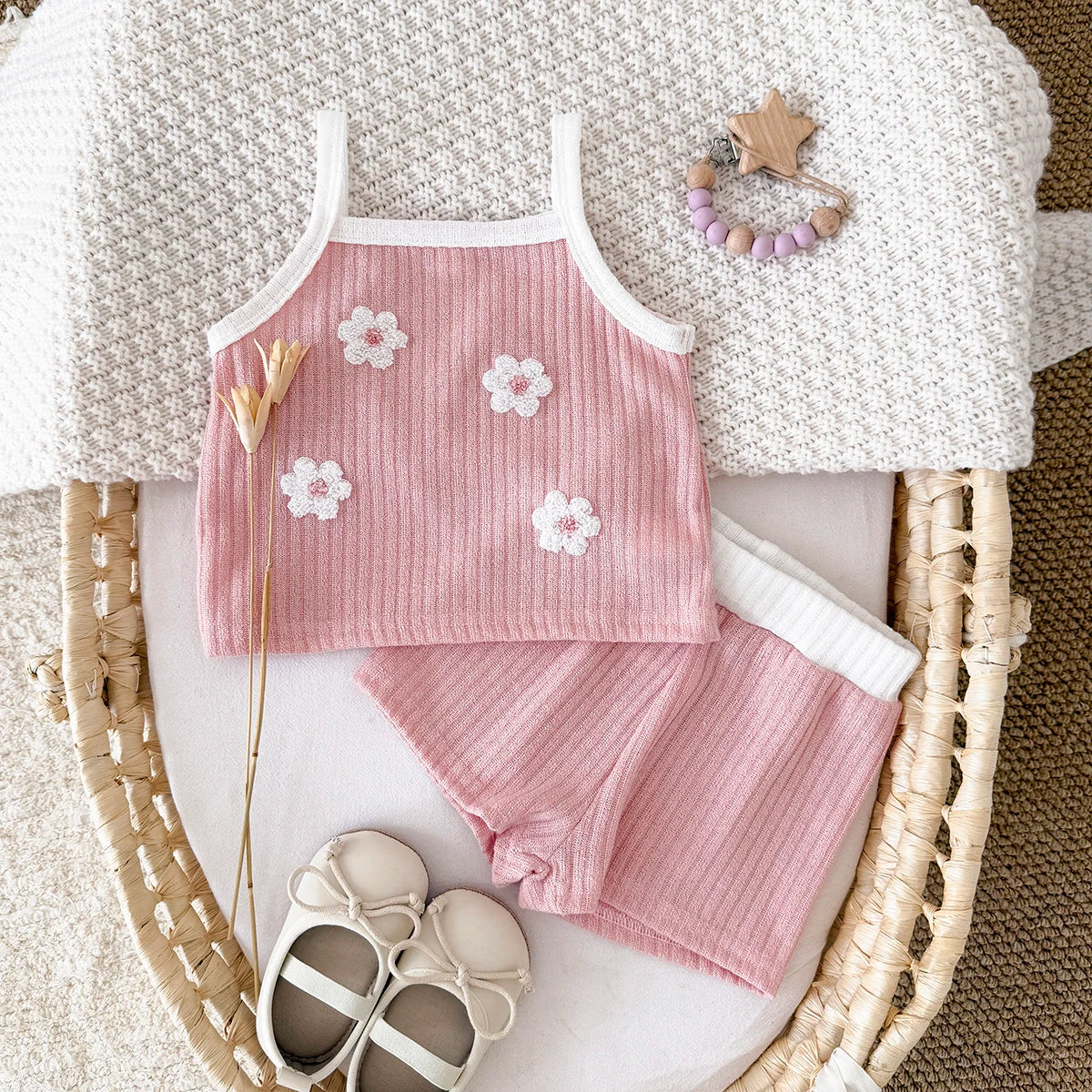 Toddler girl's summer outfit: soft ribbed knit camisole and shorts, enhanced with floral embroidery.
