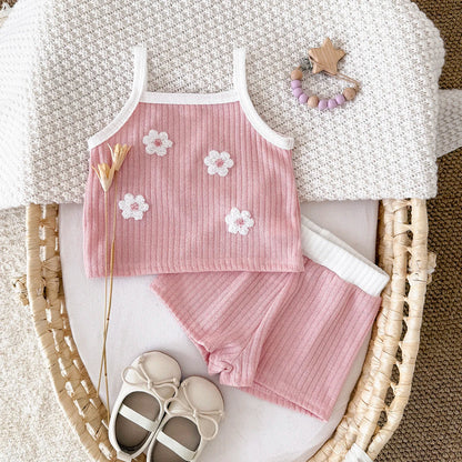 Toddler girl's summer outfit: soft ribbed knit camisole and shorts, enhanced with floral embroidery.