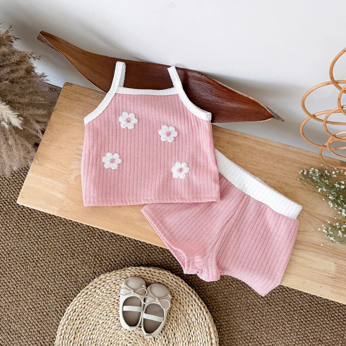 Baby girl's ribbed floral camisole and shorts set, a comfortable and stylish infant clothing option.