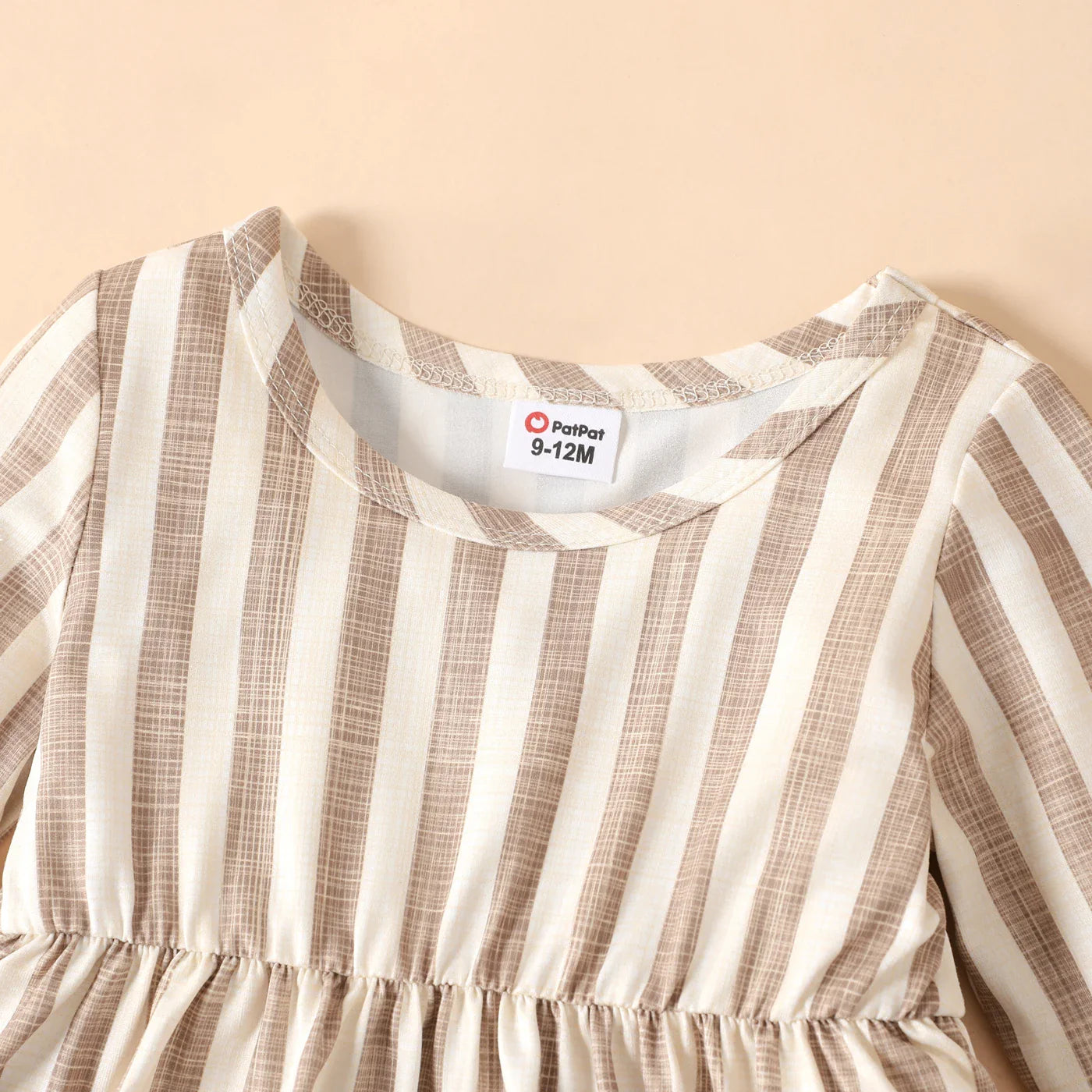 Adorable baby girl's long sleeve ribbed dress featuring a timeless striped pattern, cozy and chic
