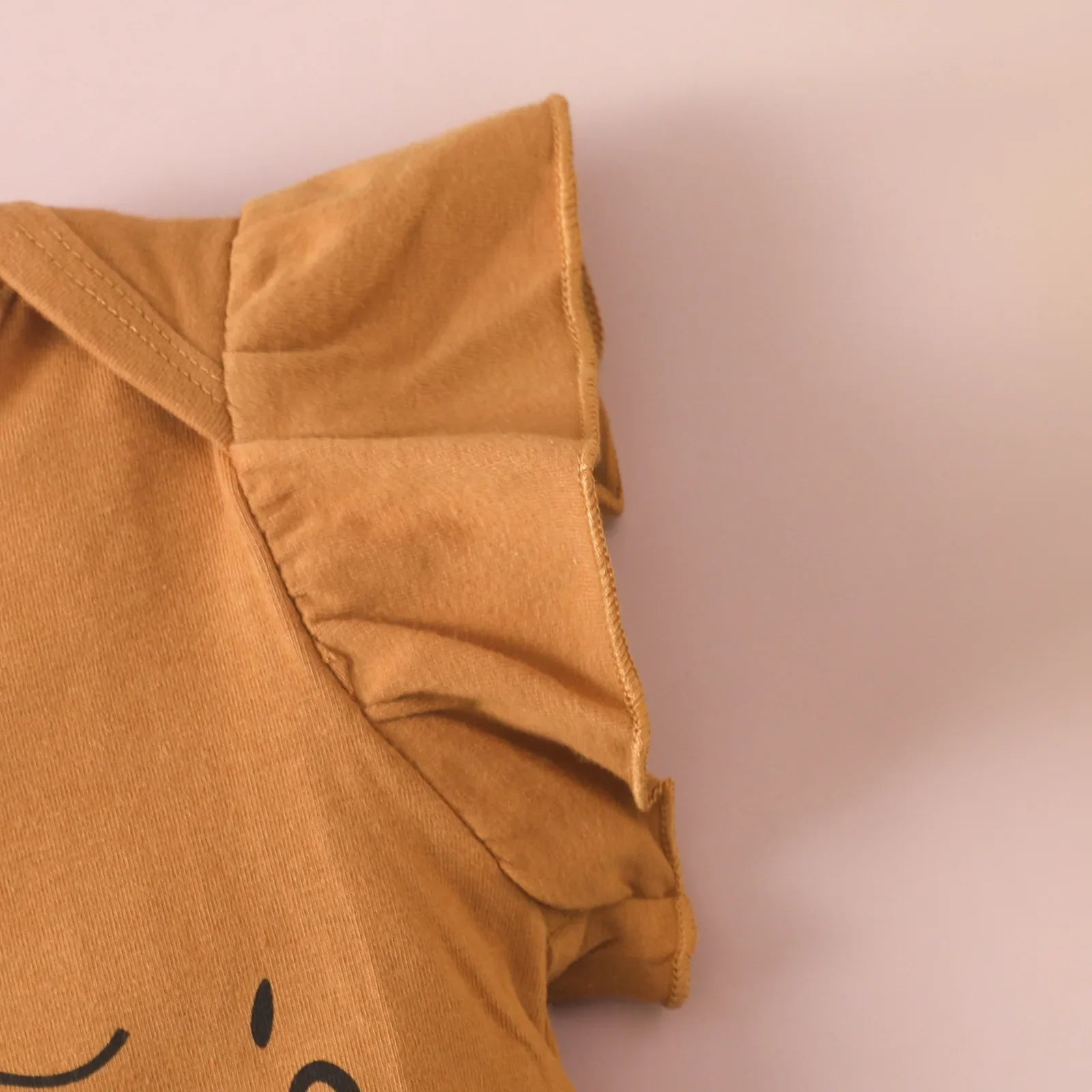 Comfortable brown toddler fashion jumpsuit, sleeveless and ruffled, for all-day wear.