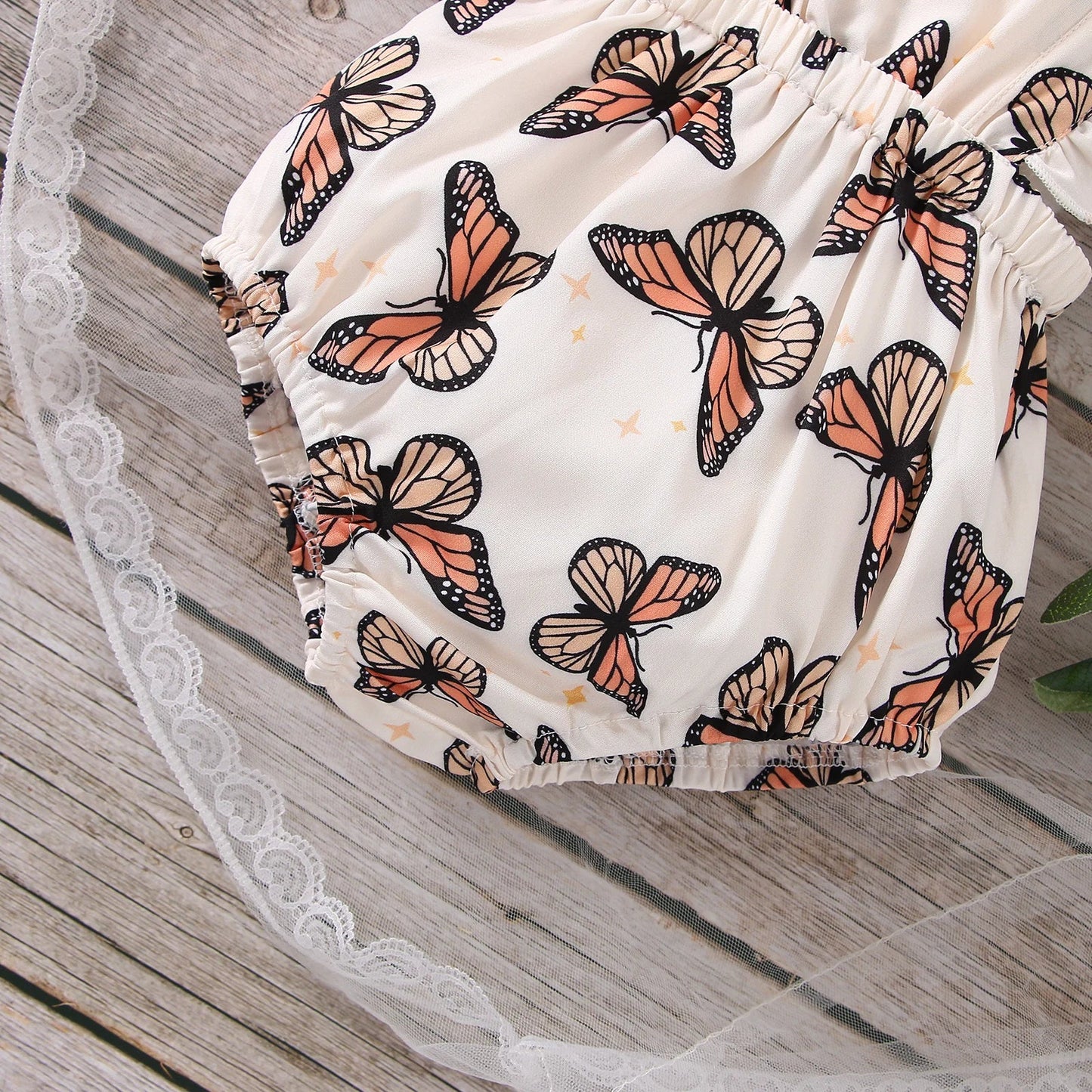 Adorable baby girl's polyester bodysuit with all-over butterfly print and sleeveless ruffle design