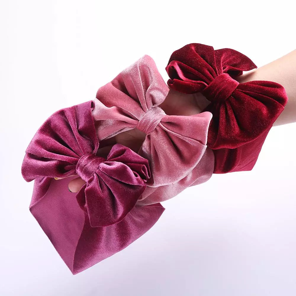 Baby girl's soft pink velvet bow winter headband, perfect for newborns and toddlers