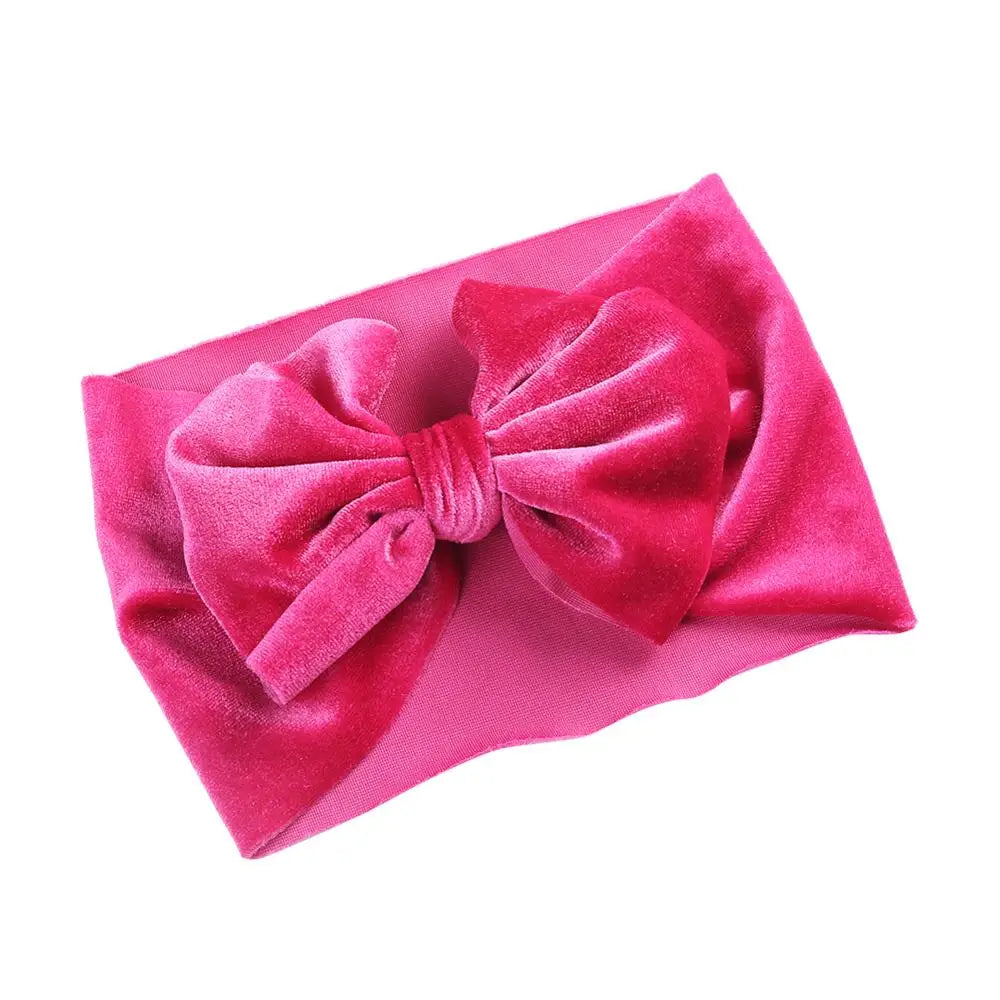 Soft pink velvet bow winter headband with a stretchable band for baby girls
