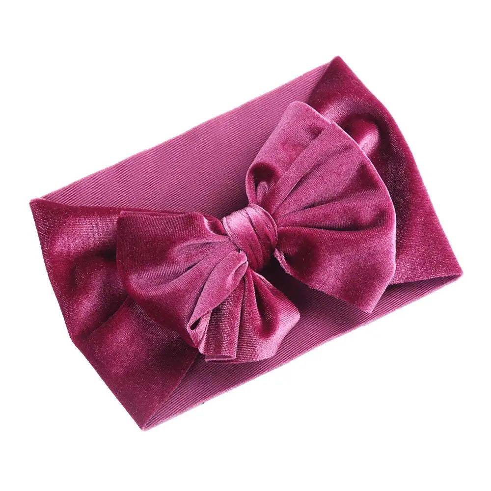 Velvet bow winter headband in a vibrant fuchsia, soft and elastic for baby girls