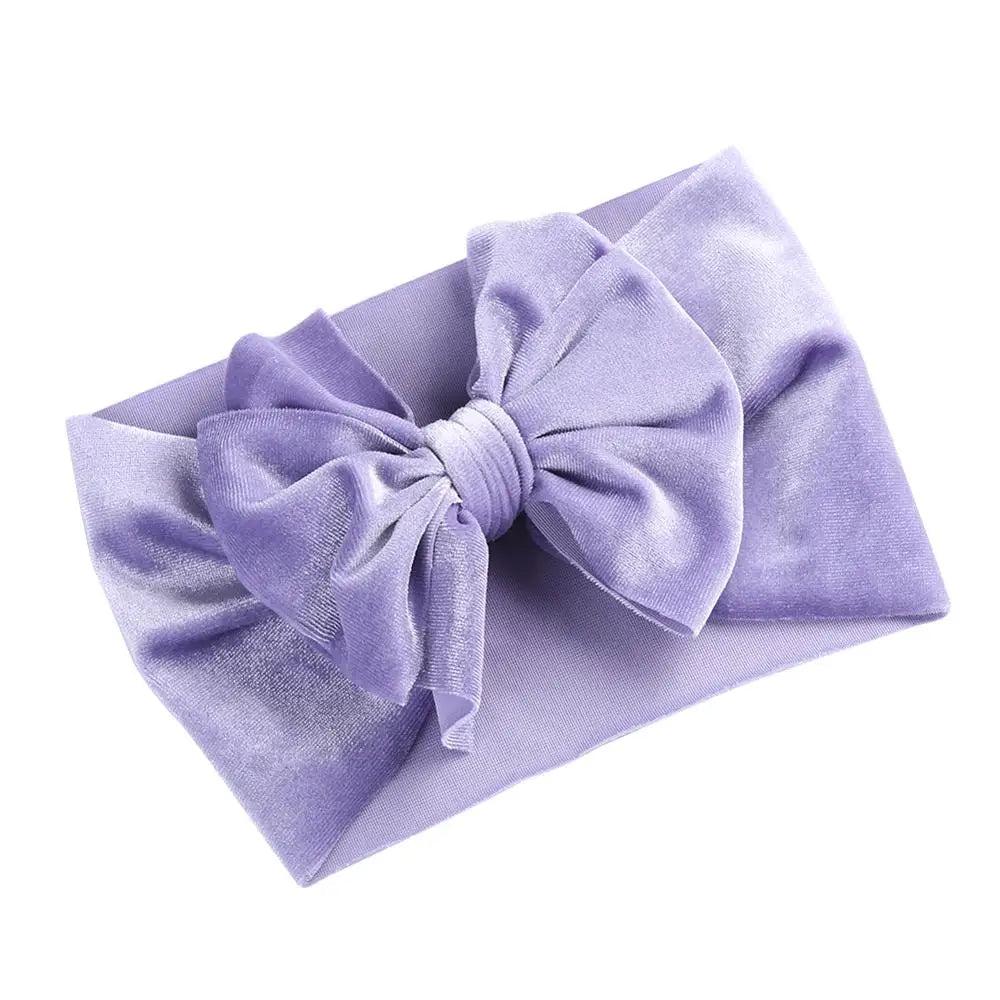 Display of assorted velvet bow winter headbands for baby girls, baby gift idea