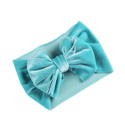 Close-up of the soft velvet fabric and bow on a baby winter headband