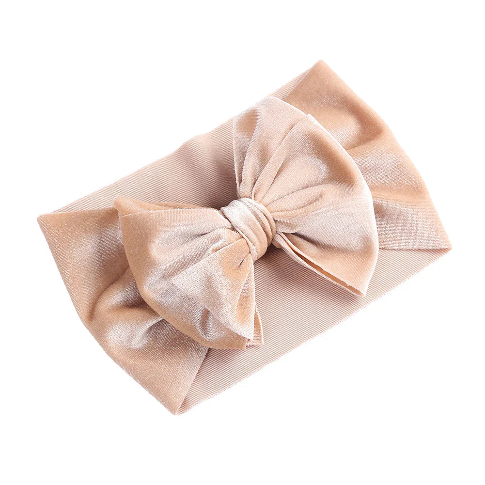 Close-up of a baby's hair with a delicate velvet bow winter headband, no slip design