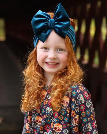 Toddler girl with a grey velvet bow winter headband, cozy and stylish hair accessory