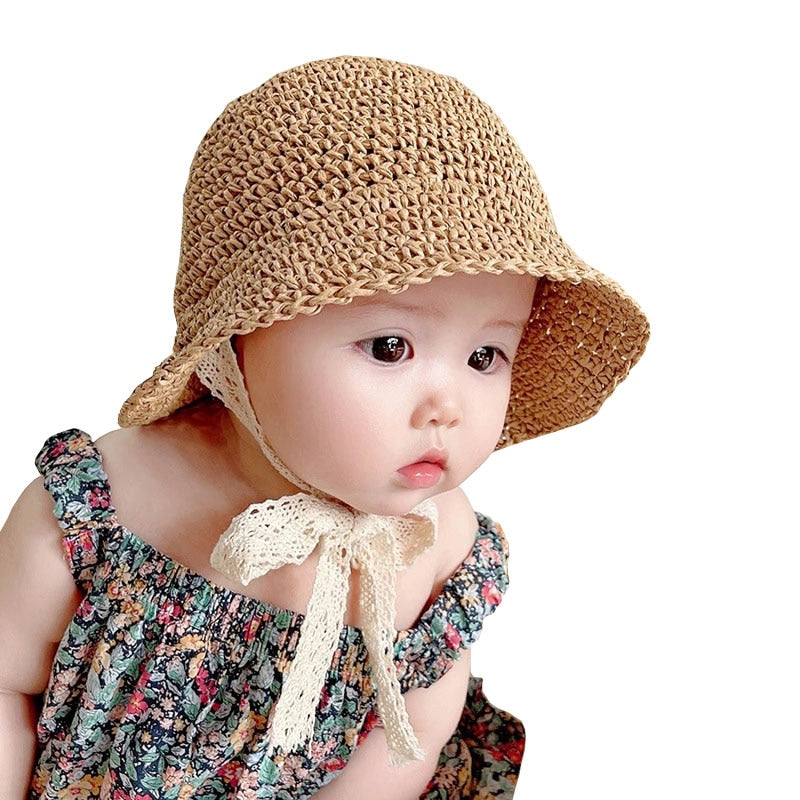 Baby girl's straw sun hat with delicate lace trim, perfect for summer beach days and sun protection.