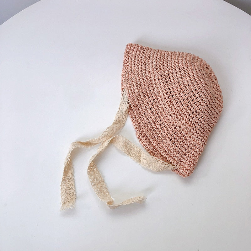 Infant girl's summer straw hat featuring elegant lace trim, ideal for sunny outdoor strolls or play.
