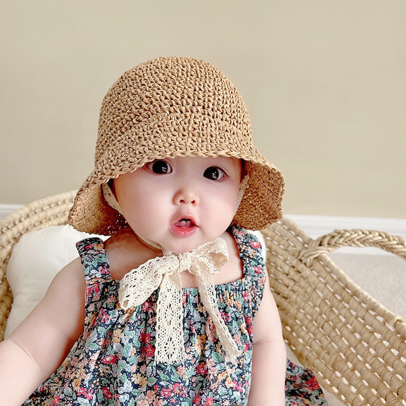Girls' straw beach hat with intricate lace trim, designed for optimal sun protection and summer fashion.