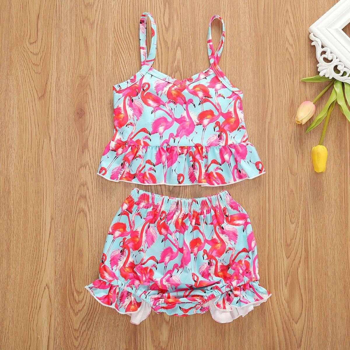 Baby girl's vibrant floral sling top & ruffled shorts summer outfit. Comfortable cotton two-piece set for toddlers.