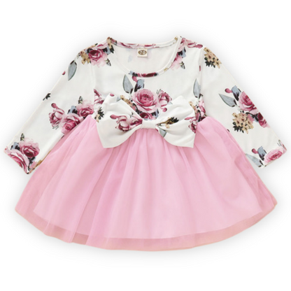 Full shot of a toddler girl's cotton blend vintage rose dress with long sleeves and bow accent.