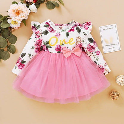 Infant long sleeve dress in a vintage rose print with a prominent bow, comfortable cotton blend.