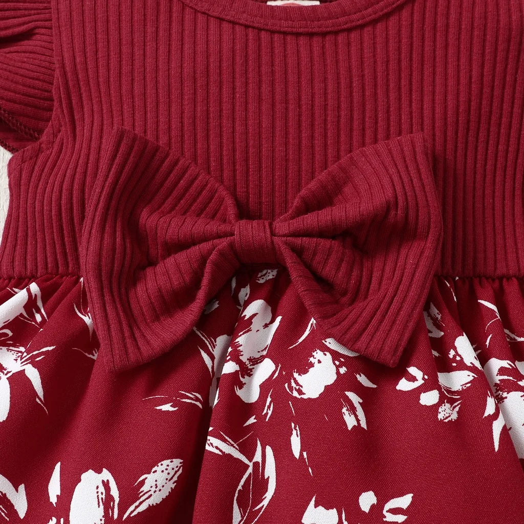 Close-up of the round neckline and puff sleeves of a baby girl's floral princess dress