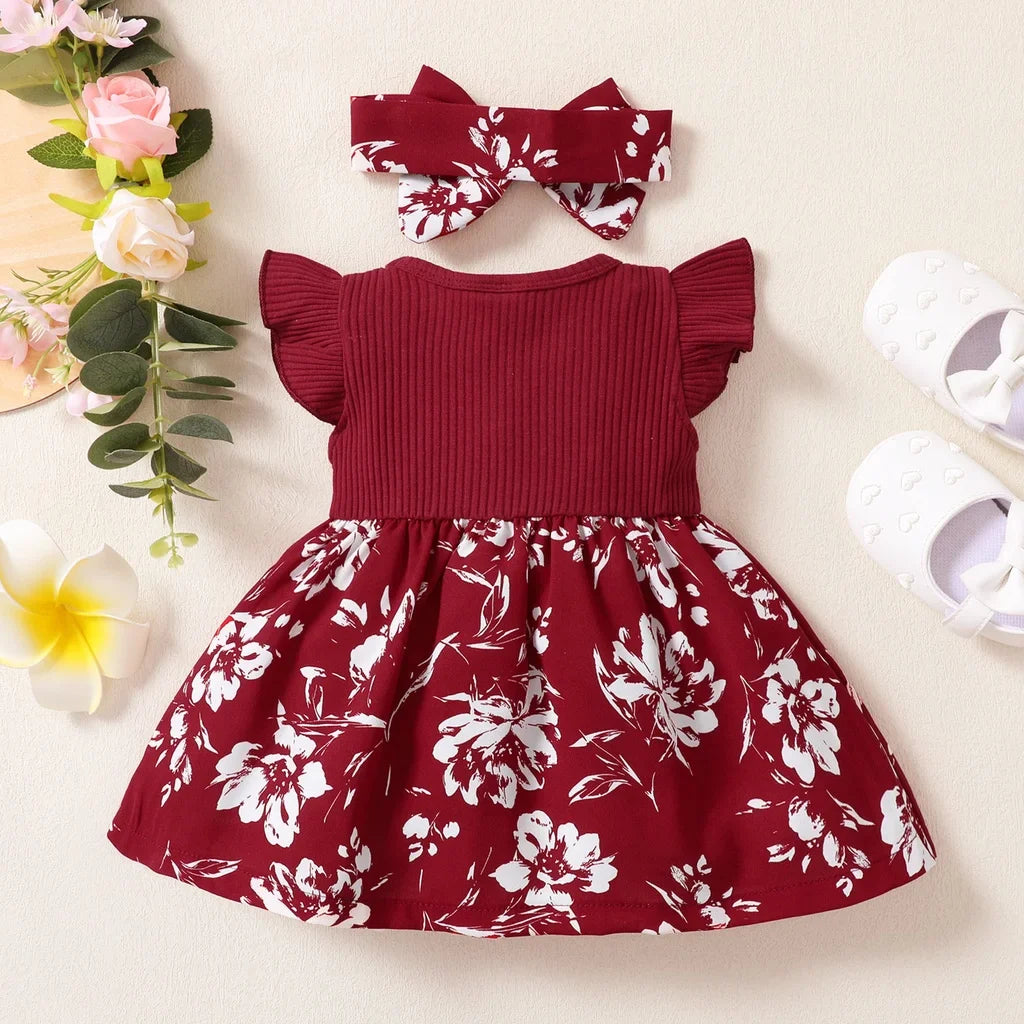 Close-up of pink and green floral print on a baby girl's cotton blend dress fabric