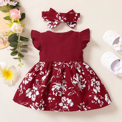 Close-up of pink and green floral print on a baby girl's cotton blend dress fabric