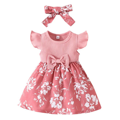 Close-up of the delicate lace trim on the hem of a baby girl's floral princess dress