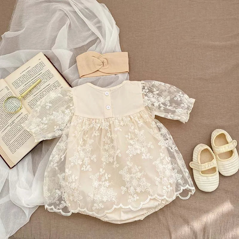 Infant wear: white cotton bodysuit with intricate lace and floral embroidery, ideal for summer.