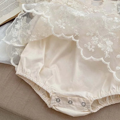Infant baby girl's summer clothing: soft cotton bodysuit adorned with lace and floral embroidery.