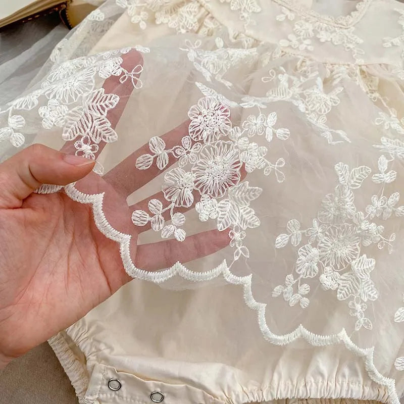 Lace and floral embroidery on a breathable white cotton bodysuit for baby girls, summer wear.