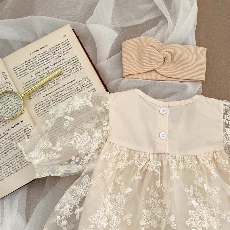 Summer baby girl's outfit: soft cotton bodysuit with detailed lace and floral embroidery.