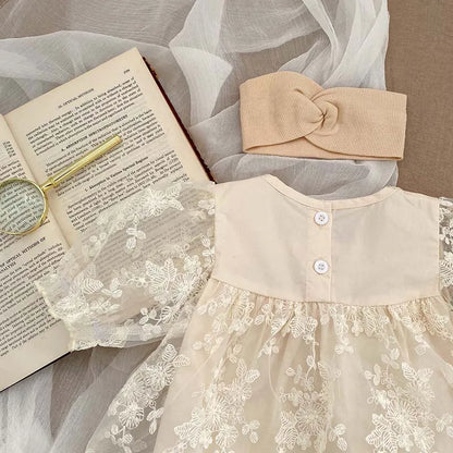 Summer baby girl's outfit: soft cotton bodysuit with detailed lace and floral embroidery.