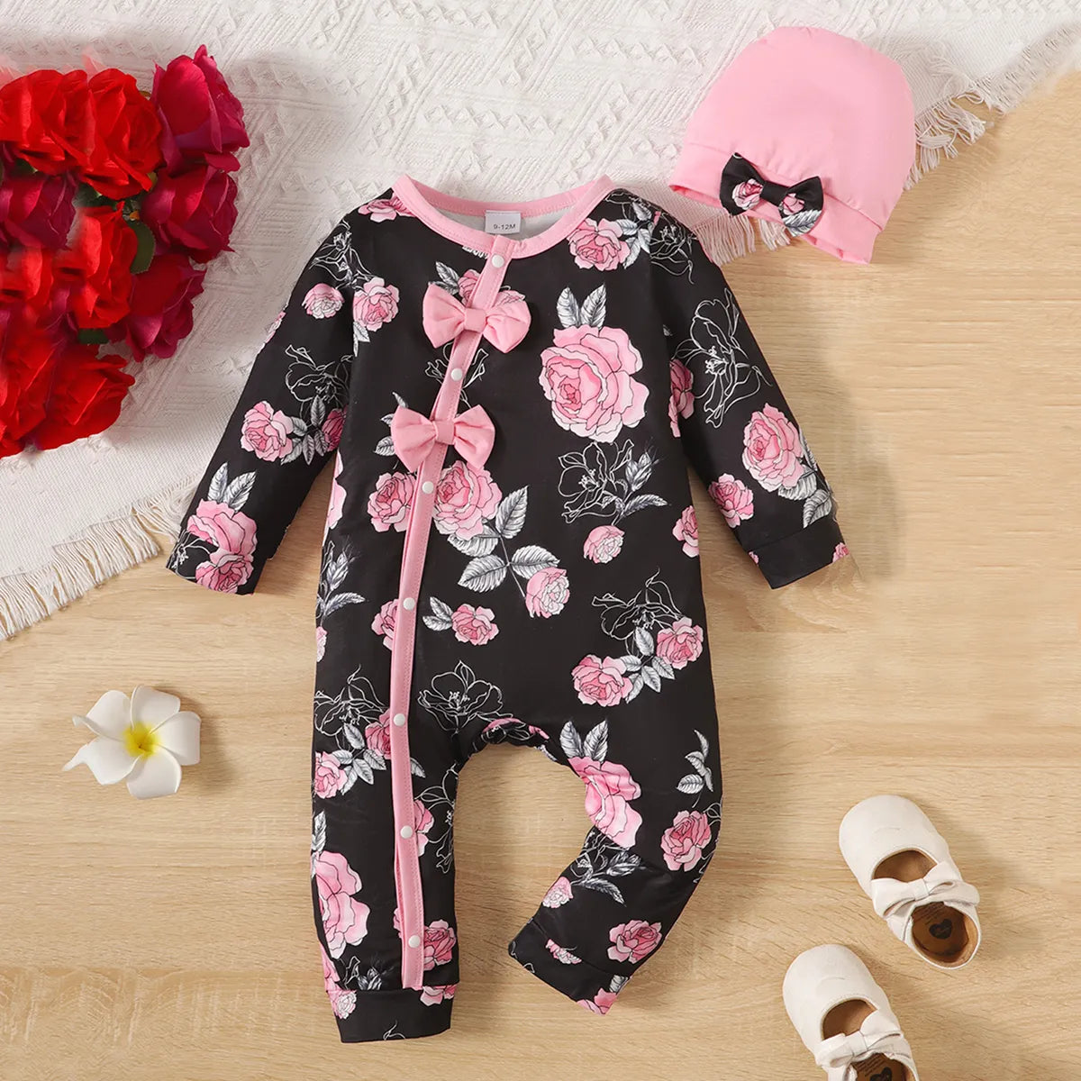 Baby girl's white floral print romper with pink bowknot, short sleeves for summer or transitional wear.