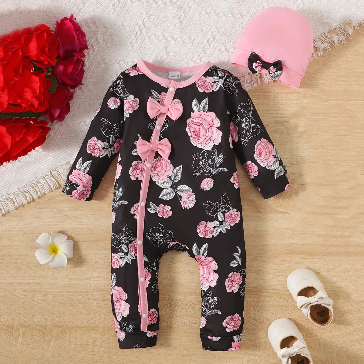 Stylish baby girl's autumn floral print romper with long sleeves and a prominent chest bowknot design.