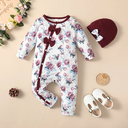 Cute close-up of a baby girl's floral bowknot romper, highlighting the print and ribbed leg openings.