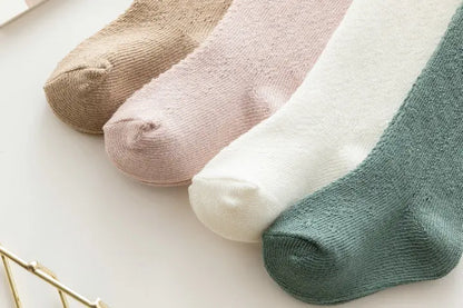 Cute hollow knit knee-high socks for baby girls in a neutral beige, soft cotton blend.