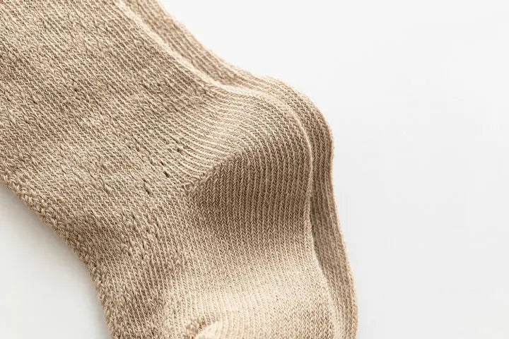 Baby girl's hollow knit knee-high socks in a classic black, stylish and breathable.