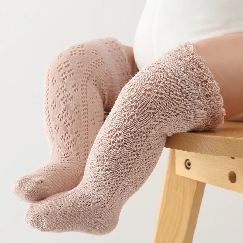 Top view of a single hollow knit knee-high sock for baby girls, emphasizing texture.