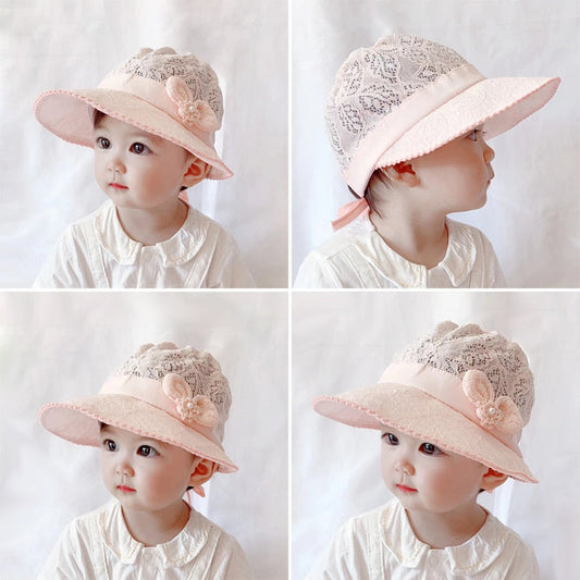 Baby girl's white lace sun hat with a wide brim, perfect for summer protection.