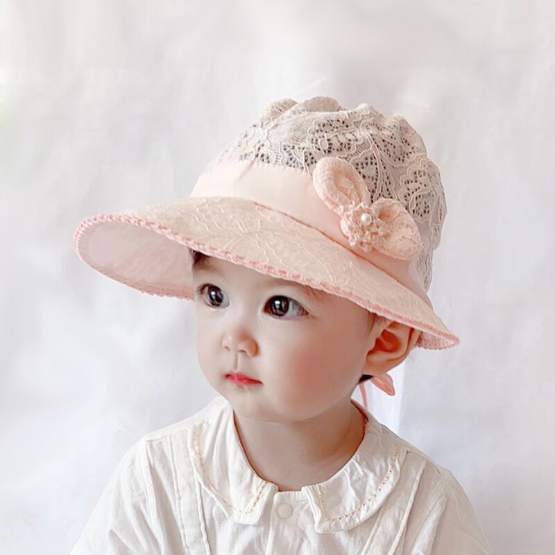Delicate lace sun hat for baby and toddler girls, perfect for outdoor summer fun.