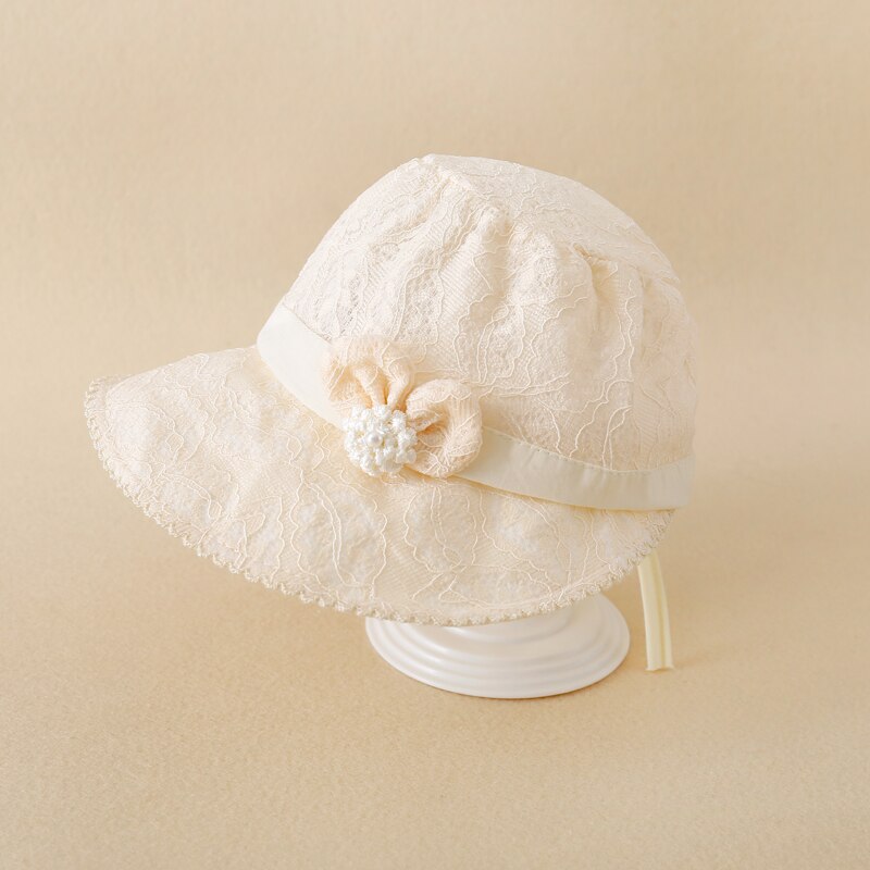 Charming baby girl's accessory: a white lace sun hat with a wide brim.