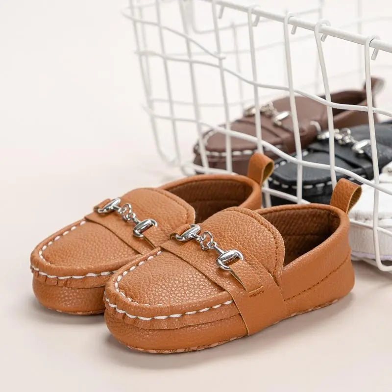 Side view of black leather non-slip soft sole casual shoes for toddlers, buckle strap