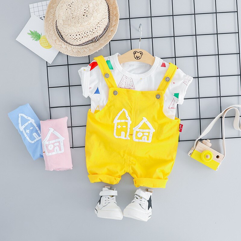 Close-up of a baby girl's house print jumpsuit fabric, showing detail of the adorable pattern and soft material