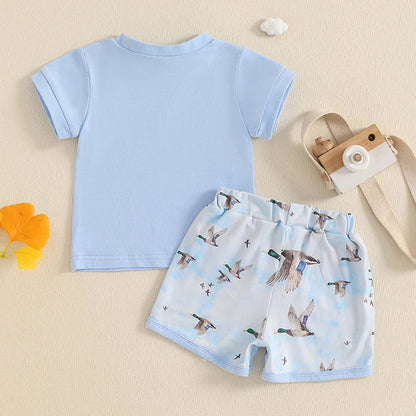 Close-up of baby girl floral print sleeveless top with ruffles and matching pink shorts