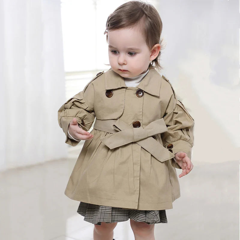 Close-up of the collar and lapels of a girls' cotton trench coat, spring outerwear detail.