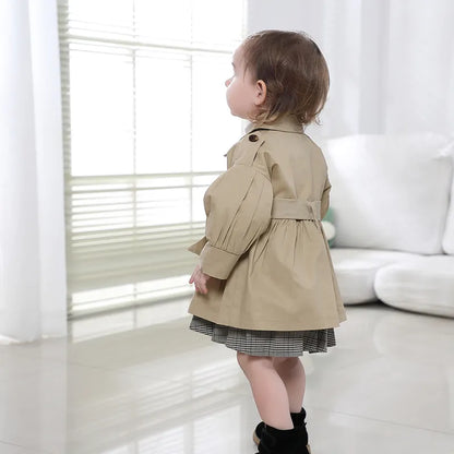 Back view of a toddler girl's broadcloth cotton trench coat, chic autumn jacket.